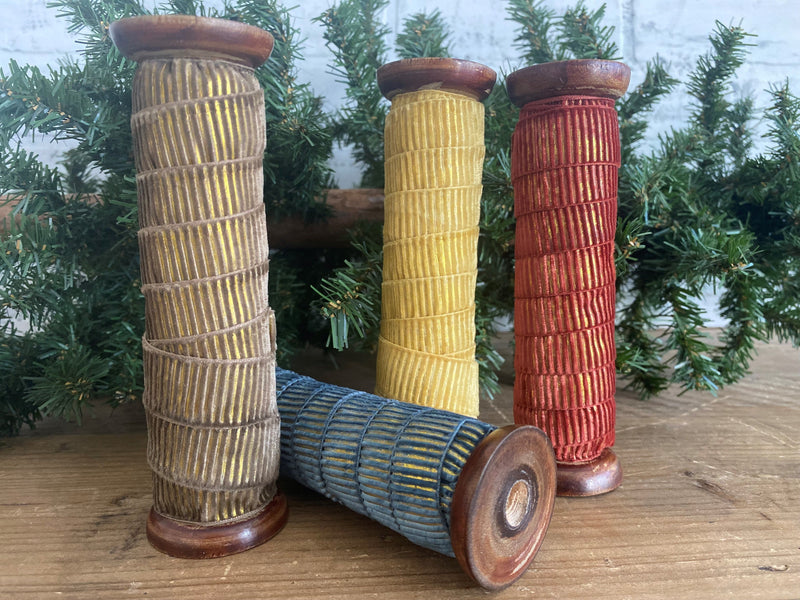 christmas holiday ribbon trimming trimmings tree present gift red yellow blue brown wood spool
